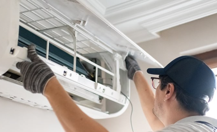 technician repairing AC